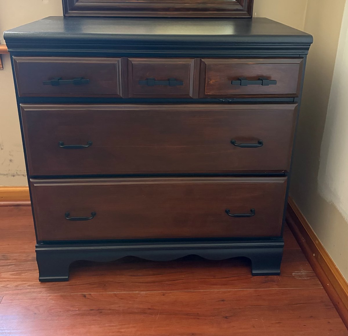 After: the full dresser seen straight on, with a black painted case and base, dark-stained drawer fronts and matte black hardware